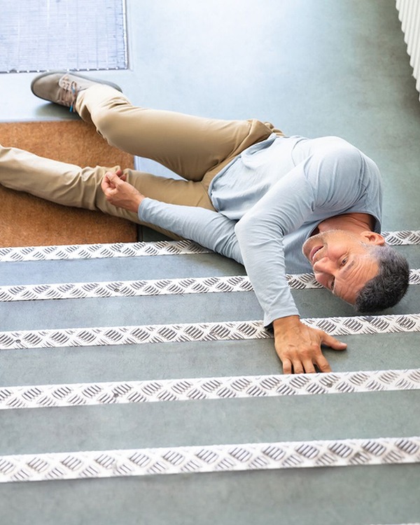 Man in pain laying on stairs after a slip and fall accident